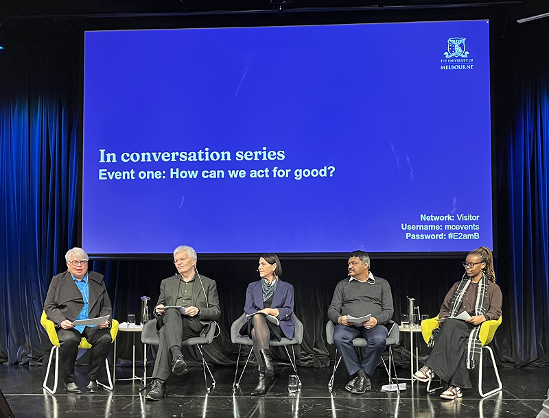 Panelists sit in front of screen that reads 'In conversation series event one: How can we act for good?